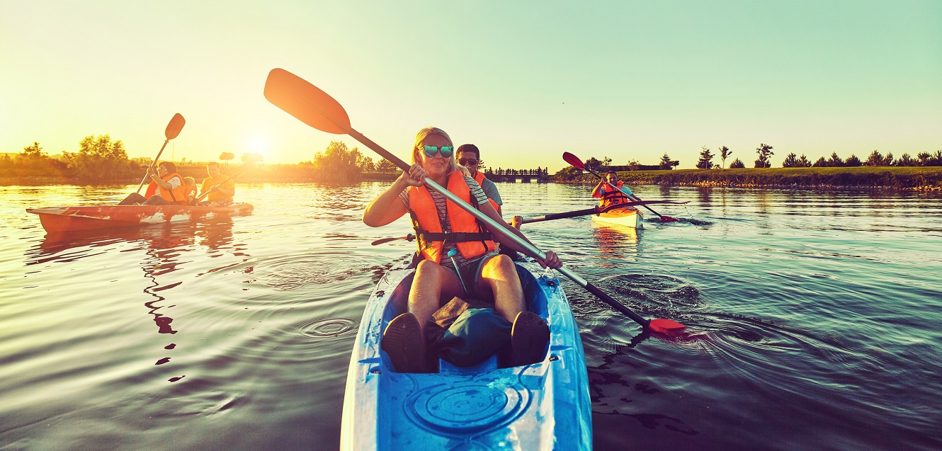 A group of kayakers on a lake.